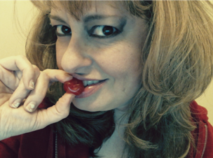 Woman nibbling on red cherry