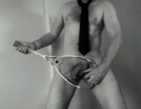 Man naked playing tennis racket guitar