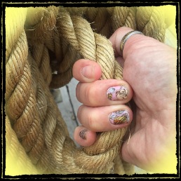 Woman with painted nails holding rope