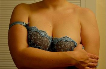 Woman taking of pretty bra