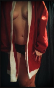 Topless woman in Santa suit