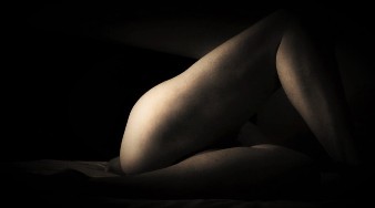 Womans legs in light and shadow