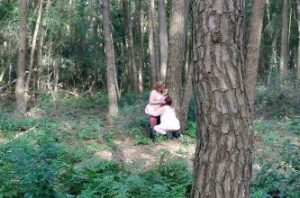 two women having sex in the woods