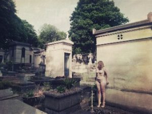 Woman naked in gothic graveyward in paris