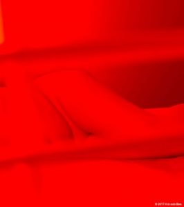 Nude woman in red light