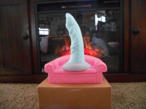 Large dildo in front of fireplace