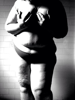 Black and white nude self portrait of overweight women