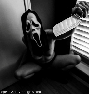 topless woman wearing scream mask and brandishing knife