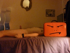 Man with suitcase head and erect penis