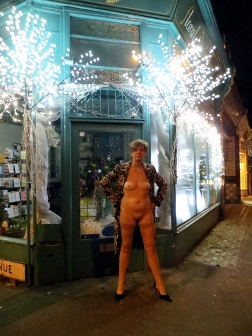 Naked woman in front of Christmas decorations