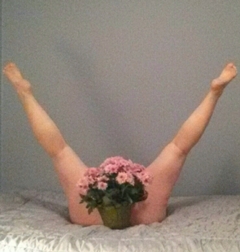 Woman with flowers between her legs