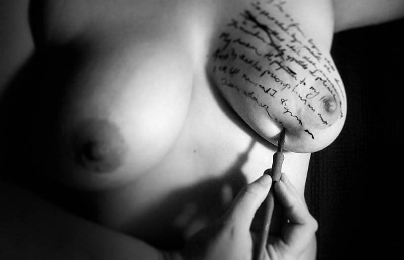 Woman with writing on her breast