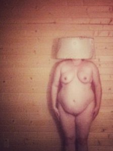 nude woman with lampshade on her head