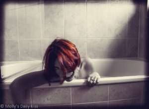 Molly in bathtub with copper hair