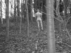 Man naked in woodland