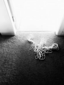 Rope on the floor in front of doorway that is light by bright day light