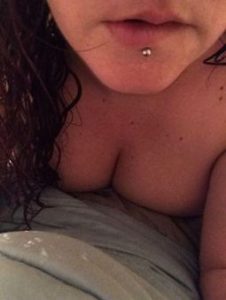 topless woman with wet hair and lip piercing