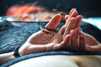 Woman with hands cuffed together with thumb cuffs