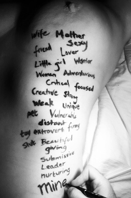 Womans body with words written on her skin describing her, like Mother, lover, wife etc