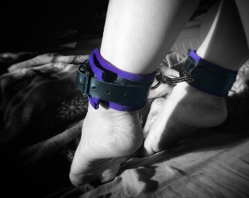 Ankles tied in ankle cuffs with colour splash purple lining