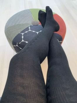 Womans legs in black patterned tights