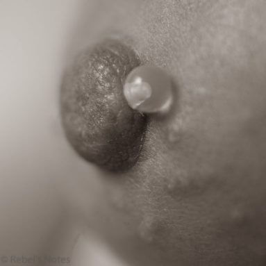 close up of womans nipple with piercing