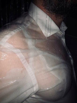 man wearing bra with wet shirt over the top