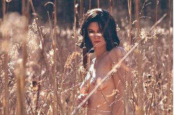 topless woman in a field