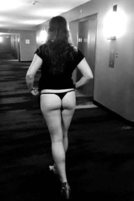 woman flash thong in hotel corridor