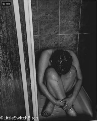 woman curled up in the shower