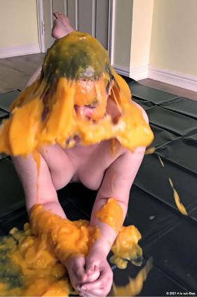 person naked with custard being thrown on their head