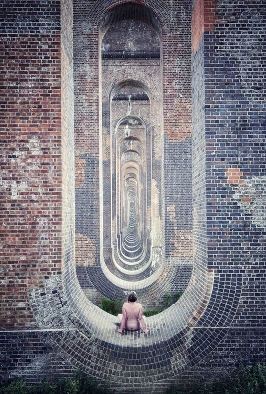 Woman sitting naked in Viaduct arch