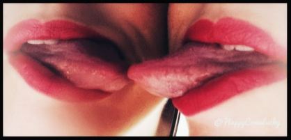 Persons lips with red lipsstick and tongue coming out touching tongue in mirror