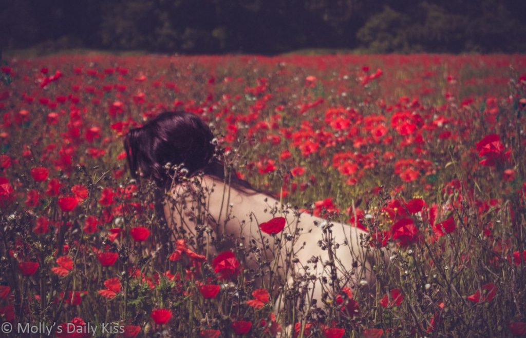 Molly leaning down naked in poppies for weekly round up 583