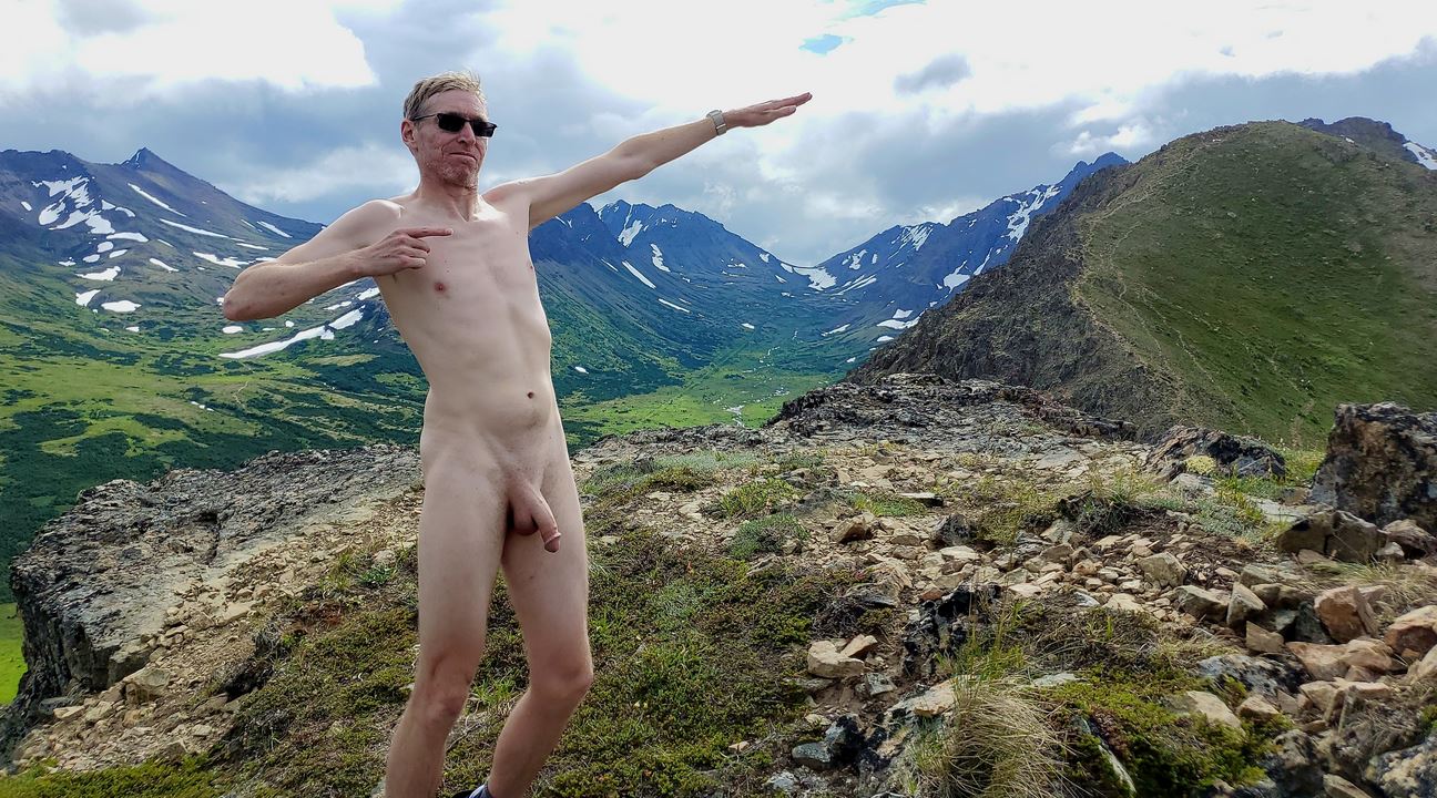 Naked man in front of mountain range in Alaska