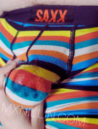 striped underpants pulled over erect penis with pre cum showing through the material