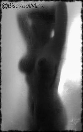 Ghostly image through shower screen of nude woman