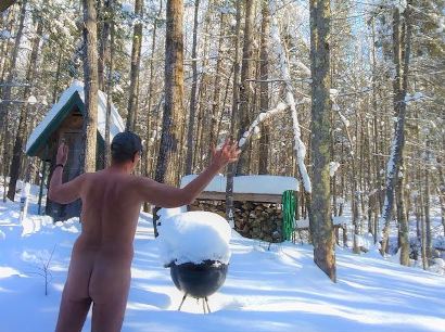 Back of nude man in front of woodland snow scene