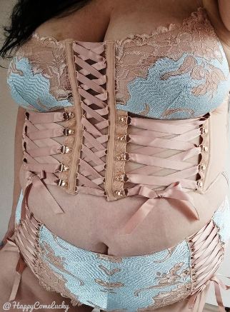 Honey wearing baby blue and peach coloured lingerie with corset bodice and lots of ribbons and bows