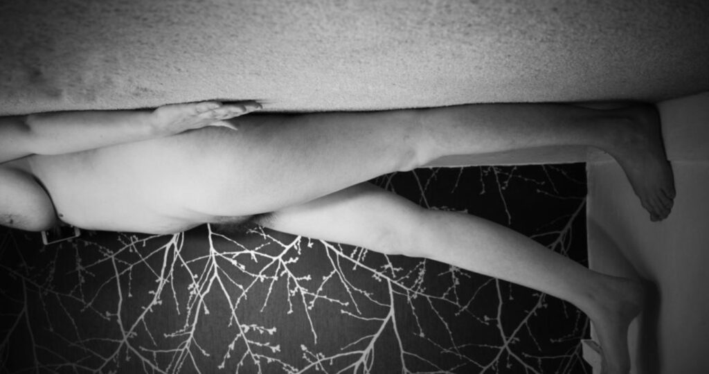 cropped image, black and white of my wild lens hanging from the ceiling walking