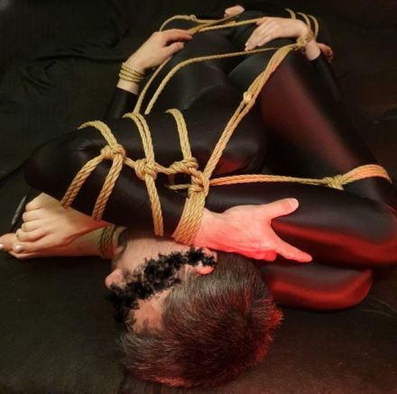 Tangle of limbs and bodies tied up in rope