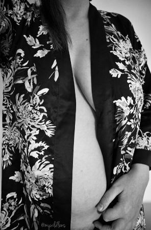 Black and white of Wild wearing patterned rope which is falling open to show her naked body