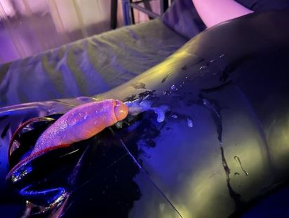 Person in latex suit with zip open and penis hanging out. There is white jizz all on the latex and on the penis