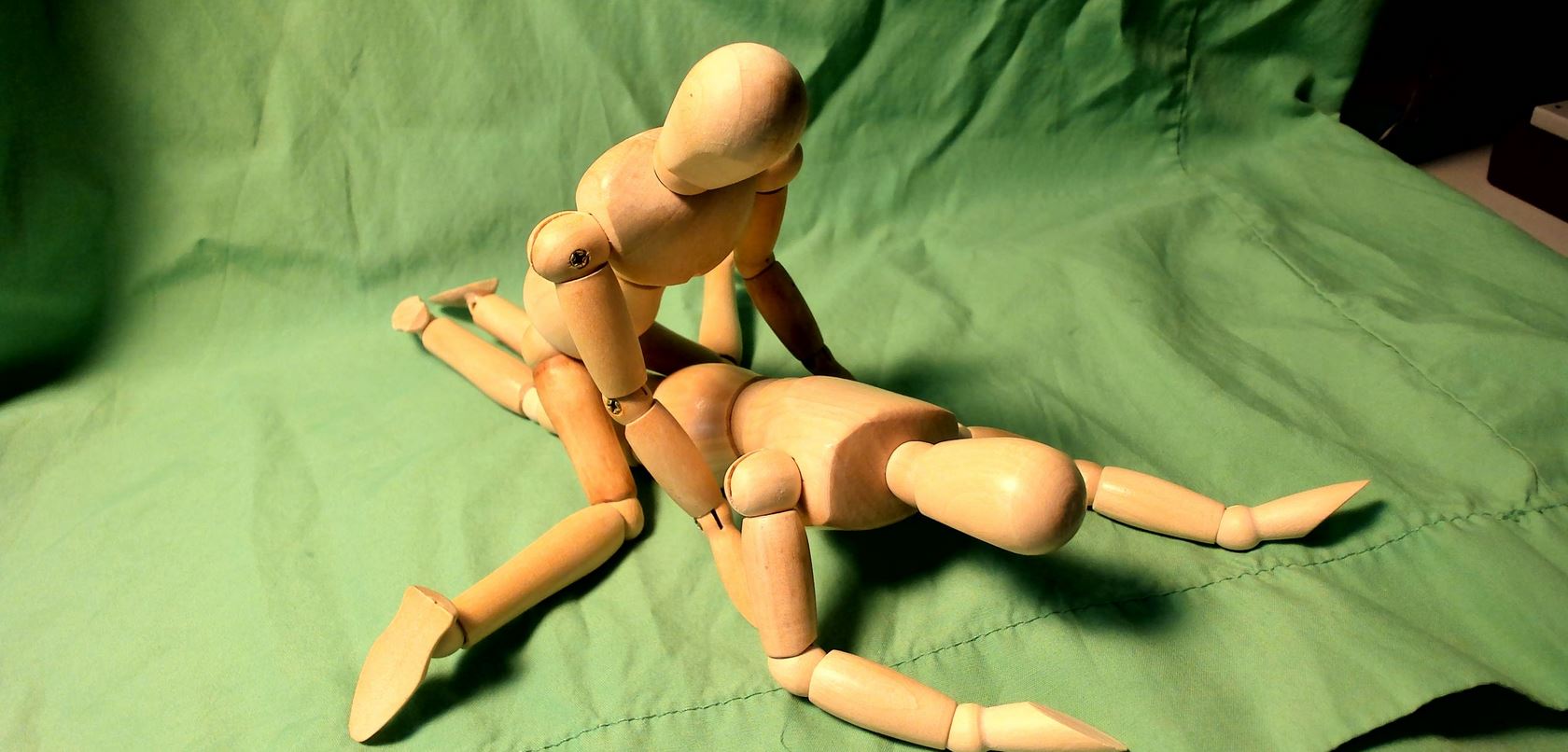 Wooden figurines set up to look like they are having doggy style sex