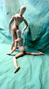 Wooden figurines set up to look like one is giving the other oral sex