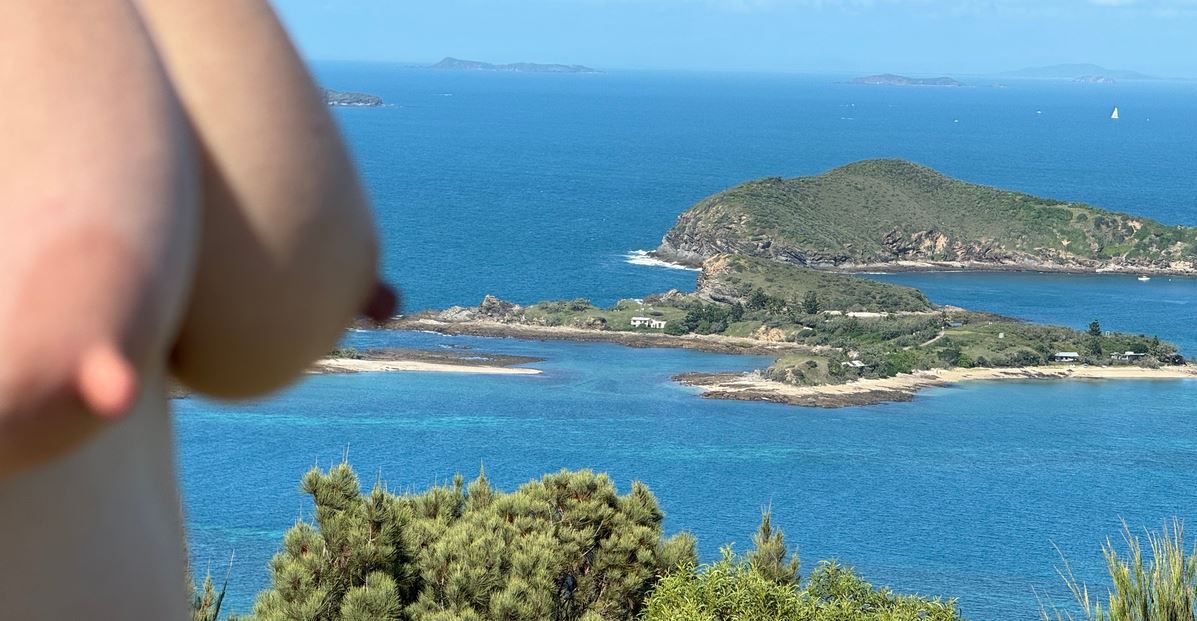 Mrs Jones breasts in soft focus in the foreground with small islands in the sea in focus in the background for weekly round-up 695