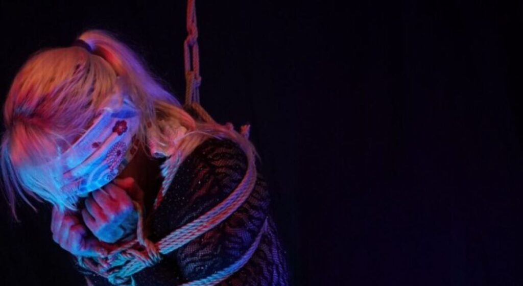 Cropped image of Bare foot sub in rope suspension with a scarf covering her eyes for weekly round-up 701